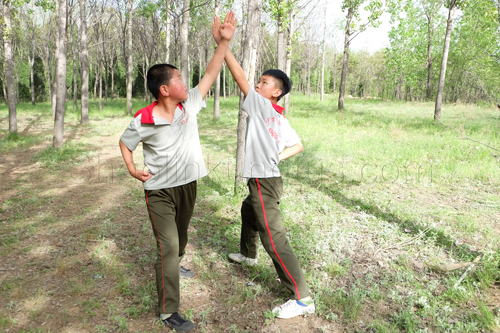 Children practicing kung fu application.